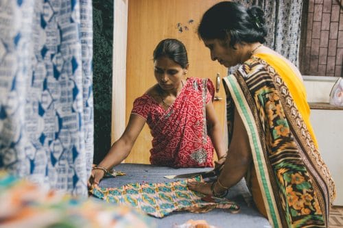 Examining fabric during Creative Handicrafts training