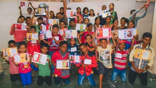 Sponsored children showing of the Christmas cards they made